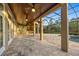 Large outdoor area with covered patio, outdoor kitchen, travertine tile and screened-in pool at 20706 79Th E Ave, Bradenton, FL 34202