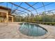 Beautiful pool area featuring a screen enclosure, travertine tile, and outdoor kitchen at 20706 79Th E Ave, Bradenton, FL 34202
