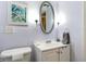 Bathroom featuring sink, toilet and decorative oval mirror at 21300 Brinson Ave # 214, Port Charlotte, FL 33952