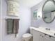 Updated bathroom with tiled floors, updated fixtures, and wall cabinet at 21300 Brinson Ave # 214, Port Charlotte, FL 33952