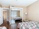 A bedroom with twin beds, wood floors and closet with mirror doors at 21300 Brinson Ave # 214, Port Charlotte, FL 33952