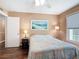 A bedroom with wood floors, a ceiling fan and large window at 21300 Brinson Ave # 214, Port Charlotte, FL 33952