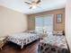 A bedroom with twin beds, wood floors, neutral walls and window at 21300 Brinson Ave # 214, Port Charlotte, FL 33952