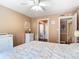 Comfortable bedroom with neutral walls, ceiling fan, and easy access to the bathroom at 21300 Brinson Ave # 214, Port Charlotte, FL 33952