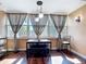 Bright breakfast nook with stylish table and chairs, illuminated by natural light from large windows at 21300 Brinson Ave # 214, Port Charlotte, FL 33952