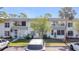 Charming townhouse-style condominiums featuring white exterior and well-maintained front lawns at 21300 Brinson Ave # 214, Port Charlotte, FL 33952