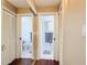Hallway with hardwood flooring, closets and access to the bathroom at 21300 Brinson Ave # 214, Port Charlotte, FL 33952