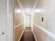 Hallway with wood floors, neutral walls, white trim, and closet space at 21300 Brinson Ave # 214, Port Charlotte, FL 33952