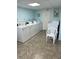 Bright laundry room with multiple washers and dryers for resident's convenience at 21300 Brinson Ave # 214, Port Charlotte, FL 33952