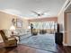 Cozy living room with hardwood floors, comfortable seating, and natural light from large windows at 21300 Brinson Ave # 214, Port Charlotte, FL 33952