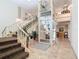 Building lobby featuring stairs and a modern glass elevator with stylish tile flooring at 21300 Brinson Ave # 214, Port Charlotte, FL 33952