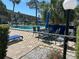 Community pool with chairs and umbrellas surrounded by a chain link fence for privacy and security at 21300 Brinson Ave # 214, Port Charlotte, FL 33952