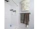 Updated shower featuring white shower walls, wall cabinet, and towel rack at 21300 Brinson Ave # 214, Port Charlotte, FL 33952