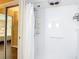 White shower featuring updated shower head and storage at 21300 Brinson Ave # 214, Port Charlotte, FL 33952