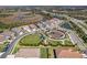 Aerial view of a community featuring beautiful homes, parks, and serene ponds at 224 Caserta Ct, Nokomis, FL 34275