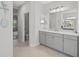 Bathroom features dual sinks, white countertops and gray vanity with tile flooring at 224 Caserta Ct, Nokomis, FL 34275