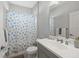 Bright bathroom features a shower/tub combo and a vanity with a large mirror at 224 Caserta Ct, Nokomis, FL 34275