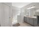 Modern bathroom featuring a walk-in shower, gray vanity with dual sinks, and updated fixtures at 224 Caserta Ct, Nokomis, FL 34275