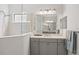 Modern bathroom showcasing a glass walk-in shower, gray vanity, and sleek fixtures at 224 Caserta Ct, Nokomis, FL 34275