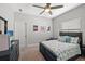 Cozy bedroom with ceiling fan, dresser, and a comfortable bed dressed in blue hues at 224 Caserta Ct, Nokomis, FL 34275