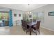 Bright dining room features a dark wood table and six chairs, leading out to the pool and outdoor patio at 224 Caserta Ct, Nokomis, FL 34275