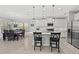 Bright, open kitchen with white cabinets, modern appliances, and an island with barstool seating at 224 Caserta Ct, Nokomis, FL 34275