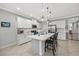 Modern kitchen featuring white cabinets, stainless steel appliances, and a spacious island with bar seating at 224 Caserta Ct, Nokomis, FL 34275