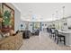 Spacious living room with tile floors, modern decor, and open-concept design, seamlessly connecting to the kitchen at 224 Caserta Ct, Nokomis, FL 34275