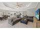 Open-concept living room showcasing a modern kitchen, dining area, and comfortable seating with natural light at 224 Caserta Ct, Nokomis, FL 34275