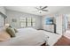 Relaxing main bedroom boasts a decorative rug, comfortable bedding, and a view of the backyard at 224 Caserta Ct, Nokomis, FL 34275