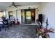 Covered patio area with outdoor seating, string lights, and a view of the pool through sliding glass doors at 224 Caserta Ct, Nokomis, FL 34275