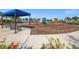 Outdoor playground with swings, slides, and shaded seating area for relaxation at 224 Caserta Ct, Nokomis, FL 34275