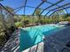 Sparkling screened-in pool featuring a serene spa and surrounding patio for outdoor entertainment at 224 Caserta Ct, Nokomis, FL 34275