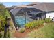 Screened pool features an inviting area for relaxation and entertaining, surrounded by lush plantings at 224 Caserta Ct, Nokomis, FL 34275