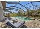 Enclosed pool area featuring a private pool, jacuzzi, patio furniture, and lush landscaping at 224 Caserta Ct, Nokomis, FL 34275