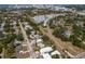 Overhead view of a residential neighborhood near a city, featuring green trees and varied home styles at 2365 Novus St, Sarasota, FL 34237