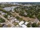 Aerial view of a neighborhood near a city with tree-lined streets, single-Gathering homes, and modern townhomes at 2365 Novus St, Sarasota, FL 34237
