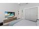 Modern bedroom featuring accent lighting, contemporary decor, and built-in media center with a large flat screen TV at 2365 Novus St, Sarasota, FL 34237