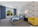 Cozy bedroom with large windows, carpet, stylish wallpaper and comfortable furniture at 2365 Novus St, Sarasota, FL 34237