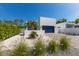 Charming single-Gathering home featuring a blue garage door, pristine white facade, and decorative landscaping at 2365 Novus St, Sarasota, FL 34237