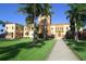 Stunning building with unique architecture, manicured lawn, and palm trees in a sunny outdoor setting at 2365 Novus St, Sarasota, FL 34237
