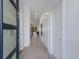 Inviting entryway featuring light wood floors, pristine white walls, and contemporary doors throughout at 2365 Novus St, Sarasota, FL 34237