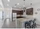Bright kitchen with granite countertops, wood cabinets, stainless-steel appliances, and modern lighting at 2365 Novus St, Sarasota, FL 34237