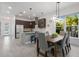 Open concept kitchen and dining area with hardwood floors, breakfast bar and stainless appliances at 2365 Novus St, Sarasota, FL 34237