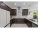 Charming kitchen featuring wood cabinetry, granite countertops, and modern fixtures with views to the outside at 2365 Novus St, Sarasota, FL 34237