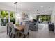 Open concept living and dining area with hardwood floors, large windows and modern decor at 2365 Novus St, Sarasota, FL 34237