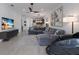 Bright open concept living room and kitchen with hardwood floors and large windows at 2365 Novus St, Sarasota, FL 34237