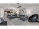 Open concept living room and kitchen with hardwood floors, large windows and comfortable seating at 2365 Novus St, Sarasota, FL 34237