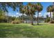 Scenic view of a lush park with a pond, trees, and green grass at 2365 Novus St, Sarasota, FL 34237