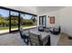Enclosed patio area featuring neutral colored lounge chairs and tropical plants at 2365 Novus St, Sarasota, FL 34237